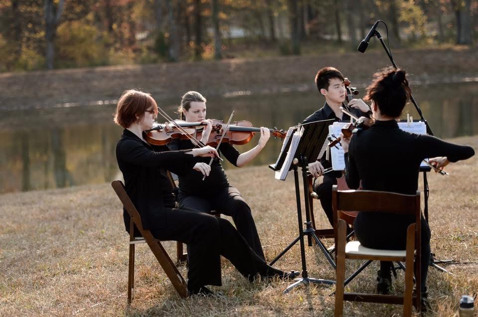 Lumina String Ensemble quartet performing at a lakeside farmhouse wedding in Atlanta, Georgia