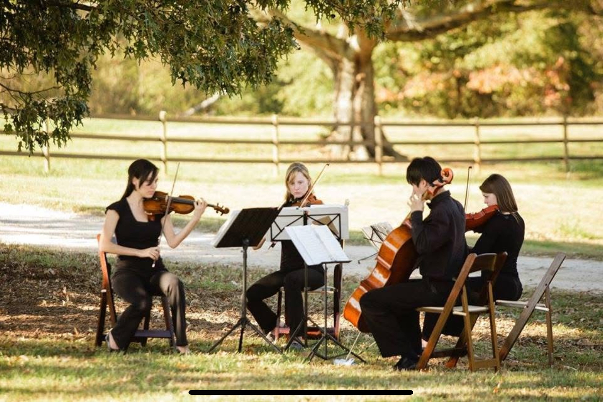 Lumina String Ensemble violinist performing at an elegant farmhouse wedding ceremony in Atlanta, Georgia